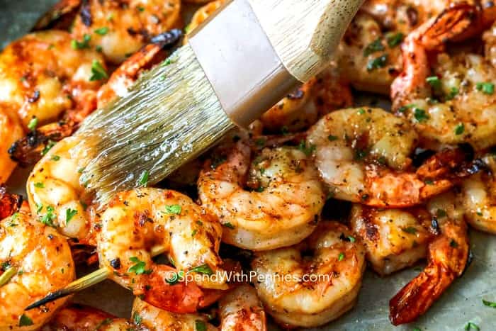 Brushing oil on Garlic Grilled Shrimp skewers