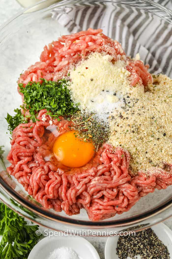 mixing ingredients to make Air Fryer Meatballs in a glass bowl
