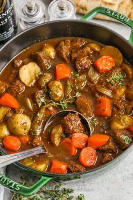 a ladle in a pot of Guinness stew