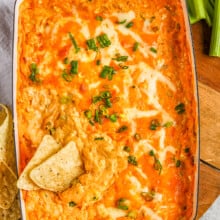 baked buffalo chicken dip with tortilla chips and celery