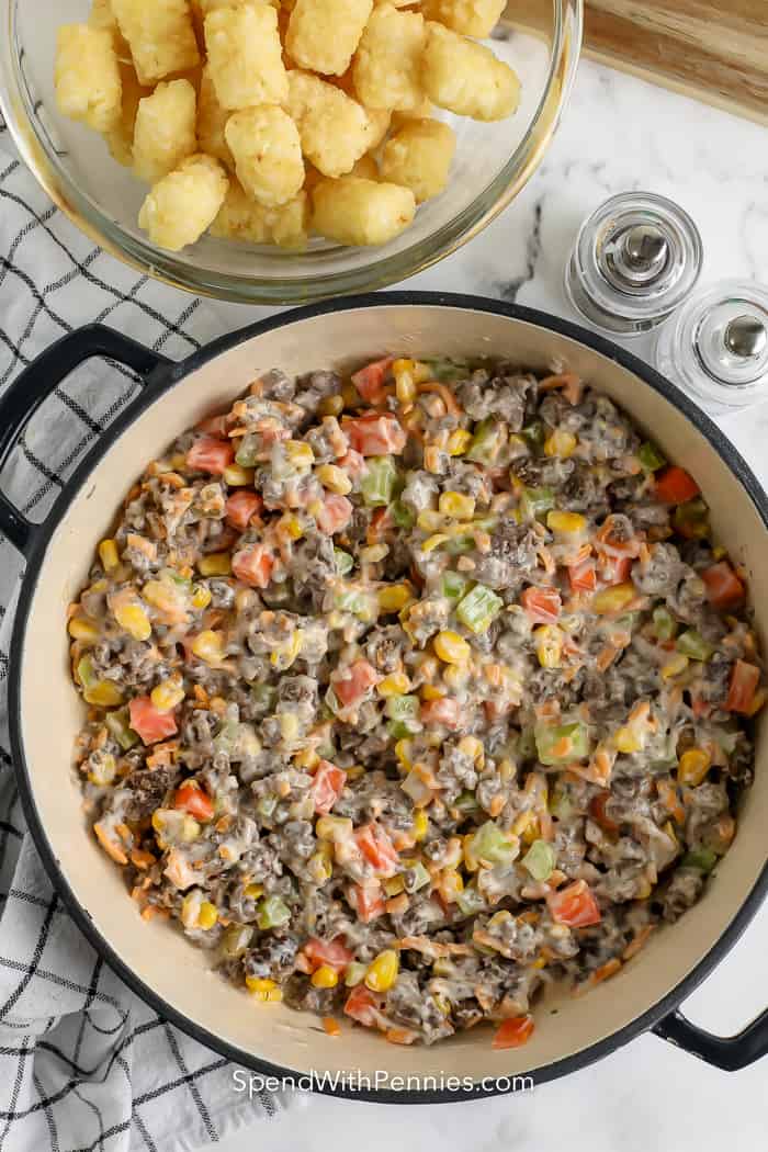 Ingredients to make classic tater tot casserole mixed together in a pot