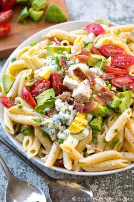 Overhead shot of Cobb Pasta Salad next to two silver spoons