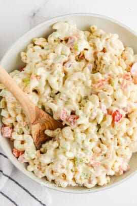 serving macaroni salad with a spoon