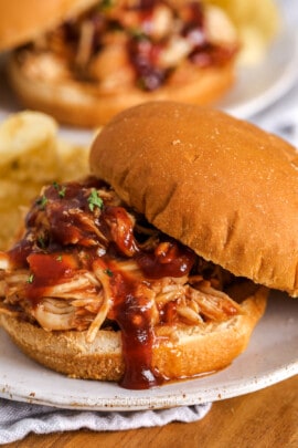 crockpot bbq chicken on a bun with potato chips
