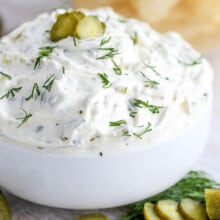dill pickle dip in a bowl with chips on the side