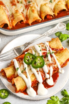 plated Easy Chicken Enchiladas and dish full in the back