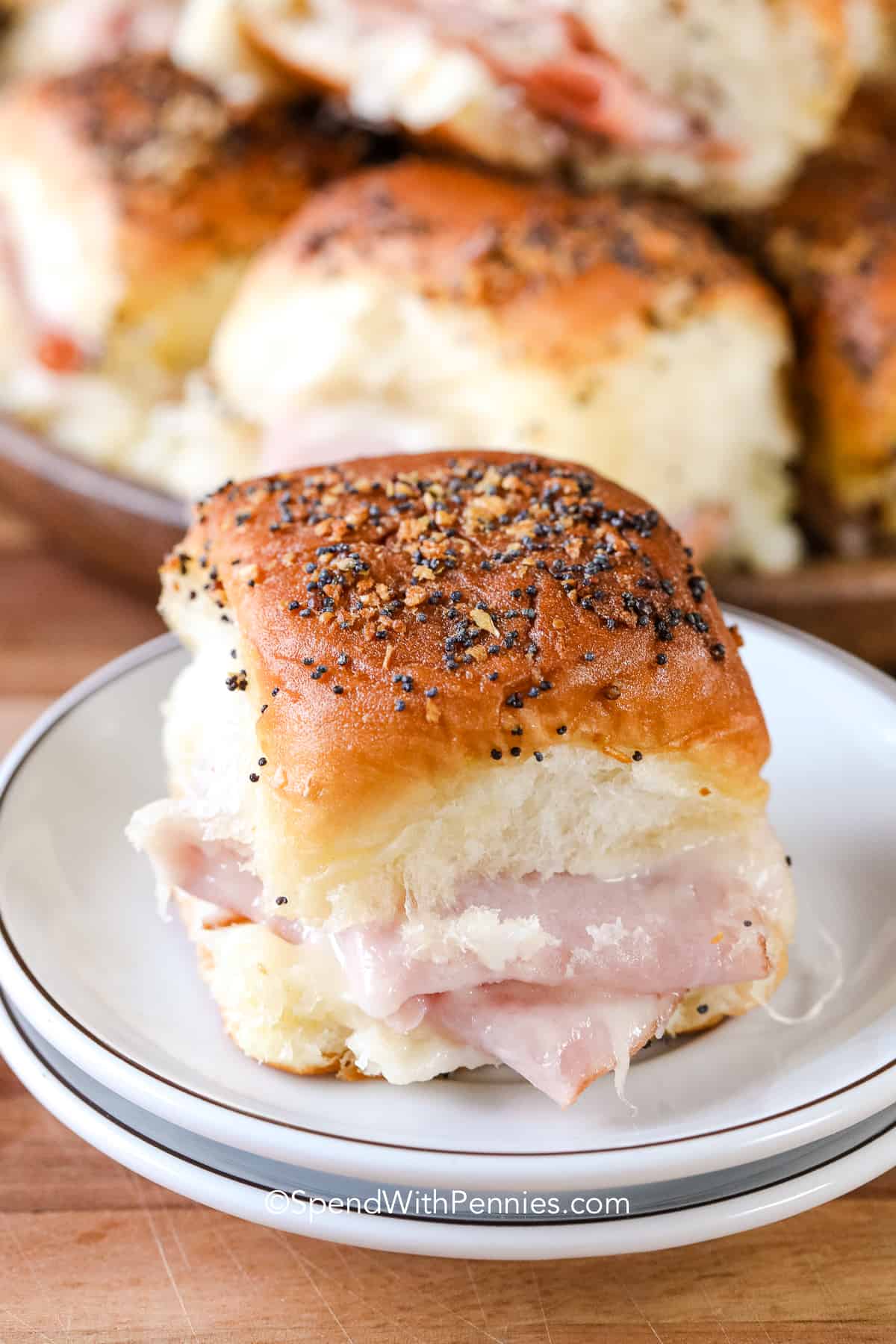 a ham and cheese slider on a white plate