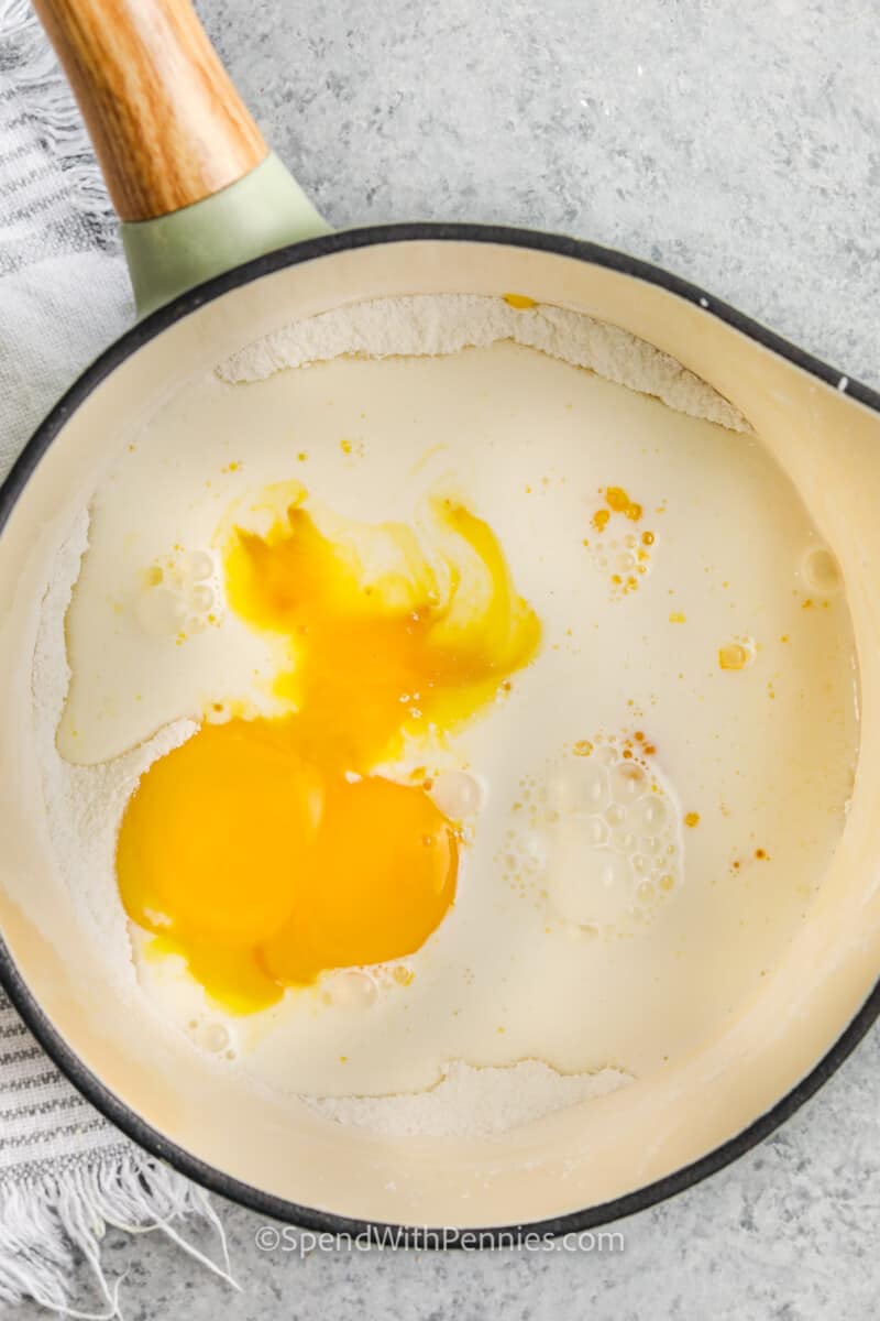 adding egg and flour to pan to make Homemade Vanilla Custard