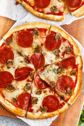 overhead view of a tortilla pizza with pepperoni and mushrooms