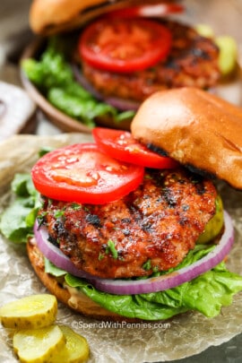 cooked turkey burger on a hamburger bun with tomatoes on top